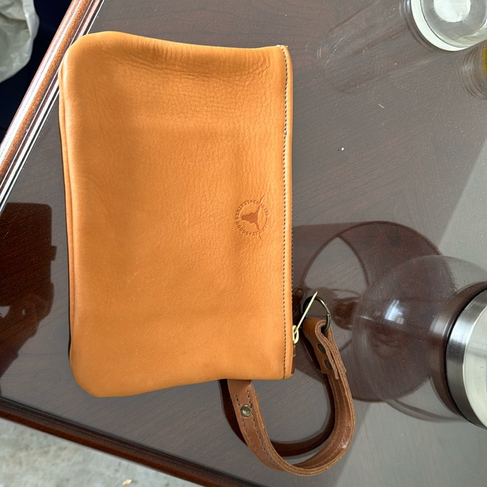 Coastal Hillbilly leather purse, wristlet strap. Excellent brand new condition.